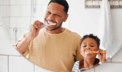 Dad Showing Son How To Brush Your Teeth