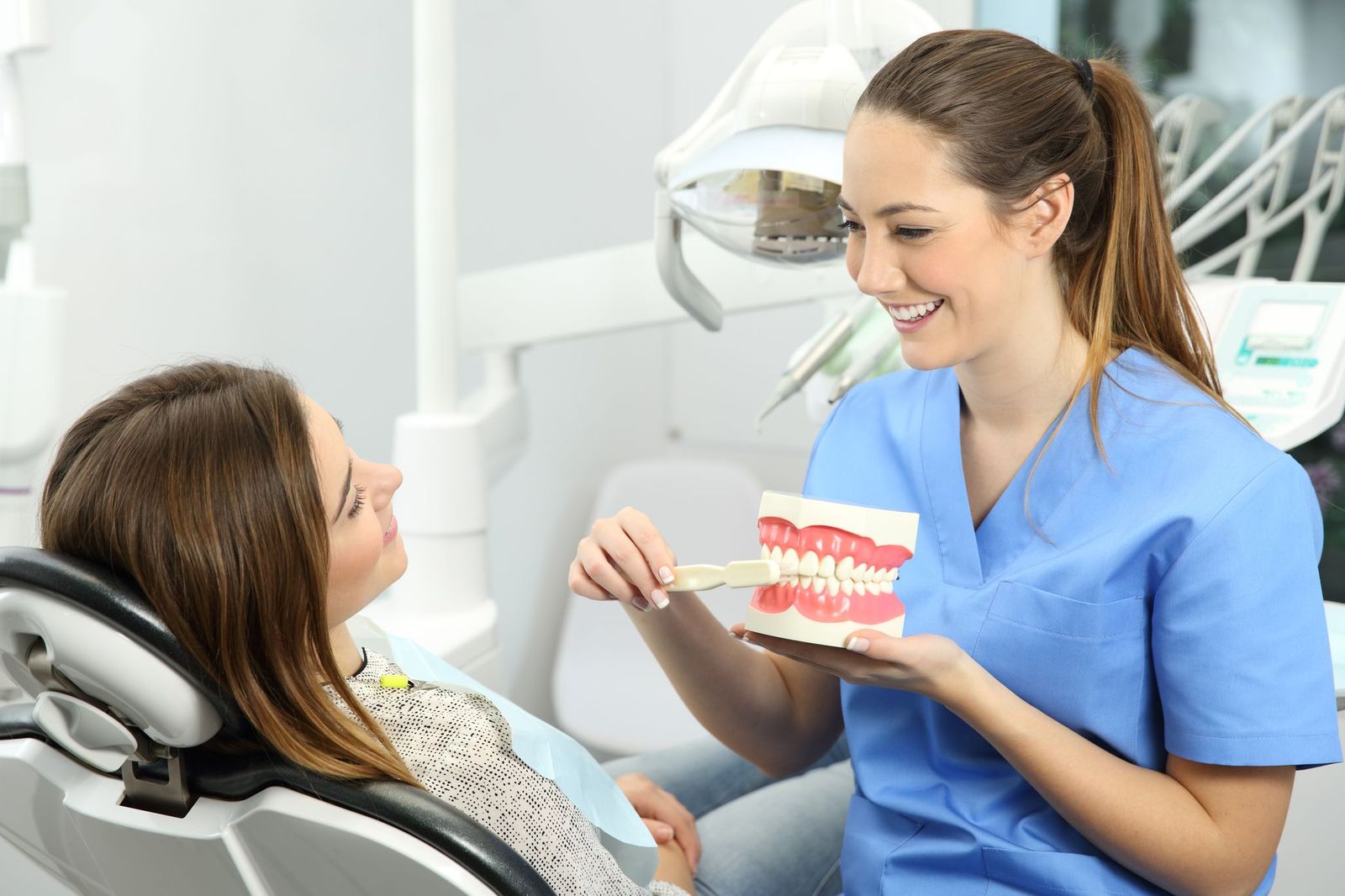 Dentist Explaining How To Brush Teeth